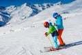 Cute skier boy with his mother having fun in a winter ski resort. Royalty Free Stock Photo