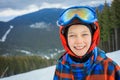 Cute skier boy in a winter ski resort. Royalty Free Stock Photo