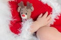 Cute sleeping baby in red hat on little bed Royalty Free Stock Photo