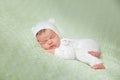 Cute sleeping newborn baby in white knitted fluffy kitten costume Royalty Free Stock Photo