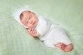 Cute sleeping newborn baby in white knitted fluffy kitten costume Royalty Free Stock Photo