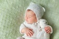 Cute sleeping newborn baby in white knitted fluffy kitten costume Royalty Free Stock Photo