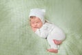 Cute sleeping newborn baby in white knitted fluffy kitten costume Royalty Free Stock Photo