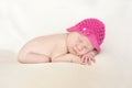 Cute sleeping newborn girl in pink hat, close-up Royalty Free Stock Photo