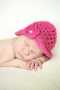 Cute sleeping newborn girl in pink hat, close-up Royalty Free Stock Photo