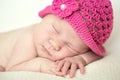 Cute sleeping newborn girl in pink hat, close-up Royalty Free Stock Photo