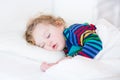 Cute sleeping toddler girl in a white bed