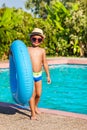 Cute small boy in hat holding inflatable ring