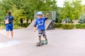 Cute small boy learning to skateboard Royalty Free Stock Photo