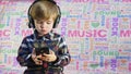 Cute small boy listening to the music in the black big headphones Royalty Free Stock Photo