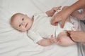 Cute small boy lying at bed. Childhood concept. Light background