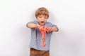 Cute small boy playing with slime looks like a red gunk Royalty Free Stock Photo