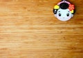 Cute small geisha face on wooden background Royalty Free Stock Photo