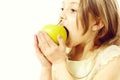 Cute small girl eating an apple isolated on white background Royalty Free Stock Photo
