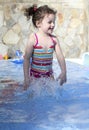 Cute small girl is playing in the swimming pool Royalty Free Stock Photo