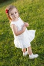 Cute small girl standing in grass