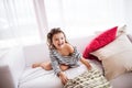 A small happy girl in striped T-shirt at home having fun. Royalty Free Stock Photo