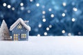 Cute small houses Christmas background with copyspace. Festive blue snowy background with Christmas lights, blurred background Royalty Free Stock Photo