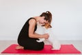 Cute small jack russell dog sitting on a yoga mat at home with her owner woman touching foreheads. Healthy lifestyle indoors Royalty Free Stock Photo