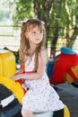 Cute small little girl riding a colorful carousel