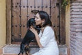 Cute small sausage dog sitting outdoors with her owner at home. Woman kissing her dog. Love for animals concept Royalty Free Stock Photo