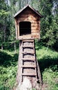 Cute small wooden dog`s House in a garden with stairs Royalty Free Stock Photo