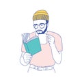 Cute smart bearded guy with glasses holding mug, drinking coffee and reading book. Portrait of thoughtful student or