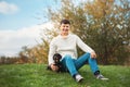 Cute smart dog and his owner young handsome man have fun in the park, conceptions animals, pets, friendship, togetherness Royalty Free Stock Photo