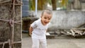 Cute smart naughty baby making a funny and looking at camera. Happy baby background