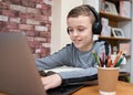 Cute smart young boy homeschooling typing work on laptop computer keyboard happy and smiling Royalty Free Stock Photo