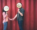 Two people holding hands while posing with funny smiles