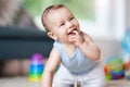 Cute smiling baby boy crawling on floor in living room Royalty Free Stock Photo