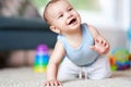 Cute smiling baby boy crawling on floor in living room Royalty Free Stock Photo