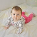 Cute smiling baby girl lying in the bed Royalty Free Stock Photo