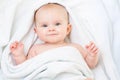 Cute smiling baby girl lying on white towel Royalty Free Stock Photo