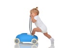 Cute smiling baby girl toddler with toy walker make first steps Royalty Free Stock Photo