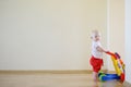 Cute smiling baby girl with toy walker