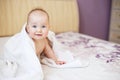 Cute smiling baby looking at camera under a white towel. portrait of a cute child Royalty Free Stock Photo