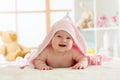 Cute baby lying on belly wrapped with pink towel after bathing Royalty Free Stock Photo