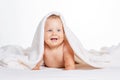 Cute smiling baby lying on towel isolated on white Royalty Free Stock Photo