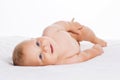 Cute smiling baby lying on towel isolated on white Royalty Free Stock Photo