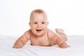 Cute smiling baby lying on towel isolated on white Royalty Free Stock Photo