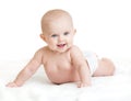 Cute smiling baby lying on white towel in nappy Royalty Free Stock Photo