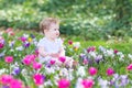 Cute smiling baby playing with first spring flowers Royalty Free Stock Photo