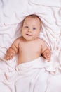 Cute smiling baby under towel after bath Royalty Free Stock Photo