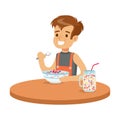Cute smiling boy having breakfast in the kitchen, colorful character vector Illustration Royalty Free Stock Photo