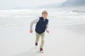 Cute smiling boy running at beach Royalty Free Stock Photo