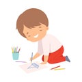 Cute Smiling Boy Sitting on the Floor on His Knees and Drawing Picture with Colorful Pencils, Adorable Young Artist Royalty Free Stock Photo