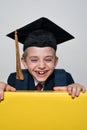 Cute smiling boy wearing in a student hat. Cheerful schoolboy. Kids education