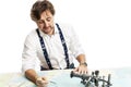 A cute smiling captain measures the distance on a map with a compass. Isolated on a white background Royalty Free Stock Photo